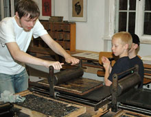 Hands-on exhibits allow visitors to experiment with an early printing press. Photo Š Deutsches Technikmuseum Berlin