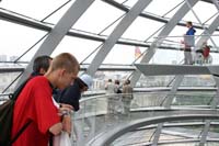 Teenagers look down from the ramp into the center cone looking into the plenary chamber.