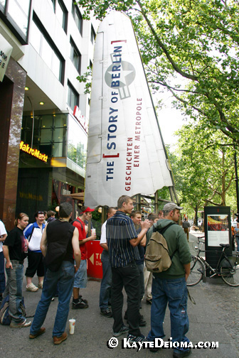 A field trip of teenage students gathers in front of the shopping center housing the Story of Berlin, Germany.