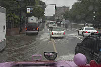 Flooded streets and a row of closed-up movie trailers on a rainy day Boston Duck Tour in Boston, MA