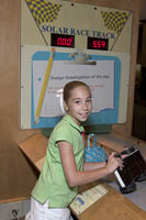 A young girl builds a scale model of a solar car at the Museum of Science, Boston, MA