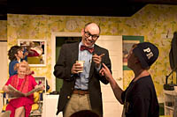 A boy from the audience gives suggestions to one of the detectives during the intermission of a Shear Madness performance at the Charles Playhouse in Boston. Photo by Kayte Deioma