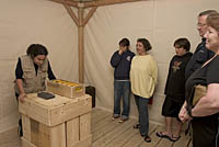 A guide gets instructions from a voice over an intercom at 5WITS Tomb, Boston, MA. Photo by Kayte Deioma