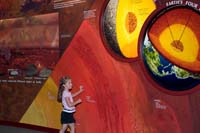 Sarah explores the textured wall of the Molten Earth Exhibit at the Cleveland Museum of Natural History