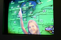 Sarah demonstrates her talents as a weather girl at the Great Lakes Science Center, Cleveland, Ohio