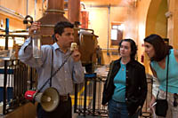 A guide holds up a bottle of undiluted tequila fresh from the still on the Jose Cuervo factory tour.
