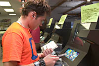 Jeff Shuter checks out a couple CDs at a listening station on the mezzanine at Amoeba Music in Hollywood. Š Kayte Deioma