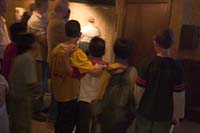 Boys cower in front of the intimidating entrance to the Ghosts and Legends special effects tour aboard the Queen Mary, Long Beach, CA.