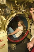 Vivian Trifonov of Los Angeles climbs through a hatch of the Russian Foxtrot Submarine "Scorpion" at the Queen Mary in Long Beach, CA