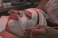 Esthetician applies a moisturizing masque to a client at the Queen Mary Spa.