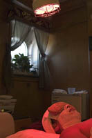 Infrared light shines on a woman getting a facial at the Queen Mary Spa aboard the RMS Queen Mary in Long Beach, CA