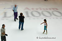 Skating instructor talks to father and daughter on the ice at Atrium Le 1000 in Montreal. Š Kayte Deioma