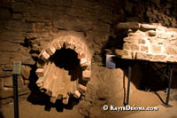 Aqueducts from the cities early sewer system poke through the walls of early building foundations at Pointe-ŕ-Calličre. Š Kayte Deioma