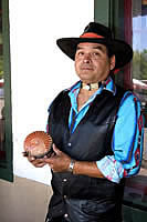 Pueblo artist Lorenzo Fuentes displays one of his pots for sale in front of the Palace of Governors as part of the Native American Artisans Program of the Museum of New Mexico.