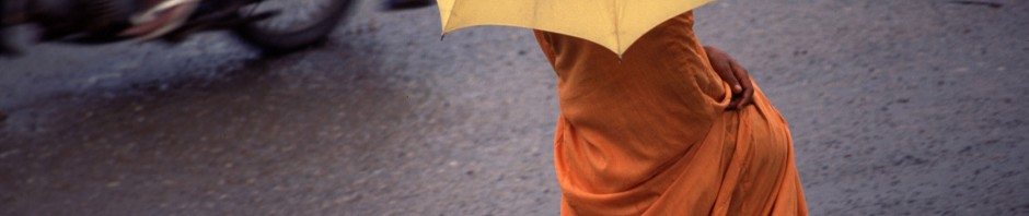 monk with umbrella in Cambodia